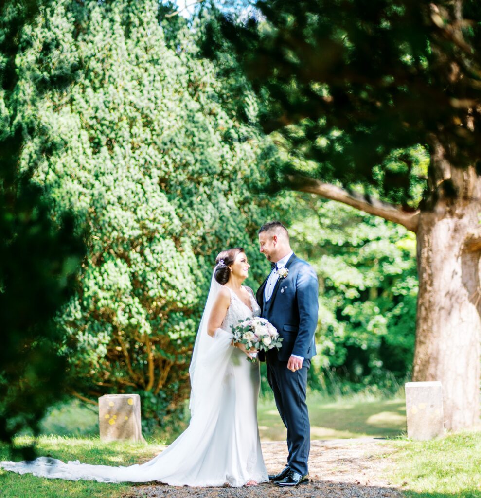 Stunning portrait of a couple in the Belleek Wood, showcasing the castle's unique natural setting.